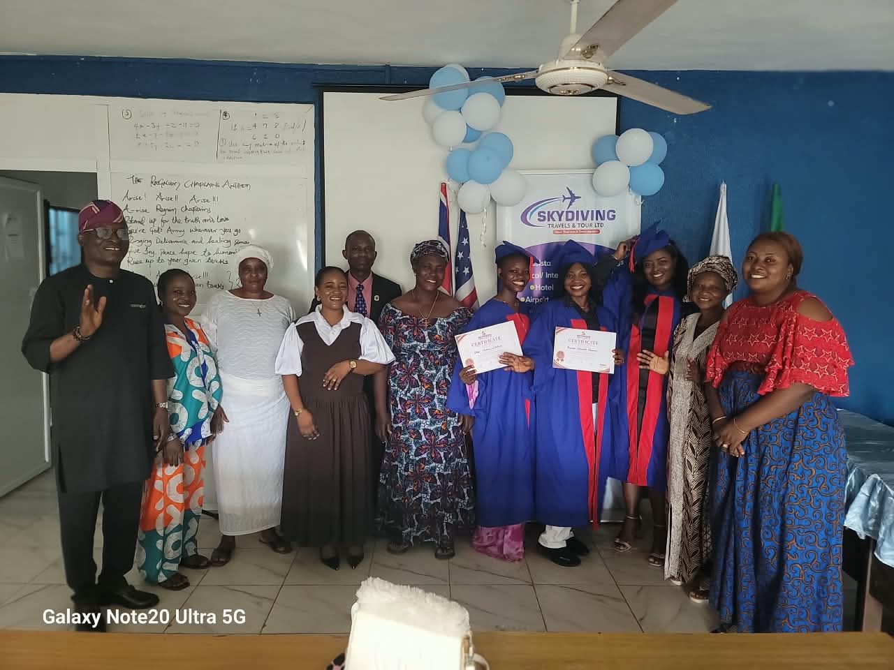 Sky Diving Travels event with learners holding certificates among a group